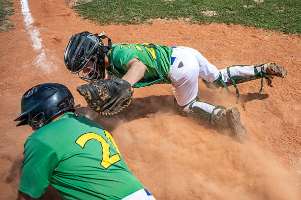 istock Baseball Player Slides Headfirst at Home Plate during Intense Play 2235510120