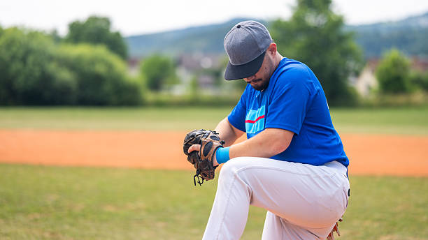 istock Baseball Player Adjusting Glove on Field 2235510138