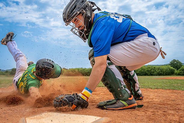istock Medium Shot Competitive Slide into Home, Catcher Awaits Tag 2235510145