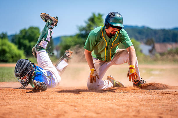 istock Baseball Player Slides Headfirst toward Base, Catcher Attempts Tag 2235510156