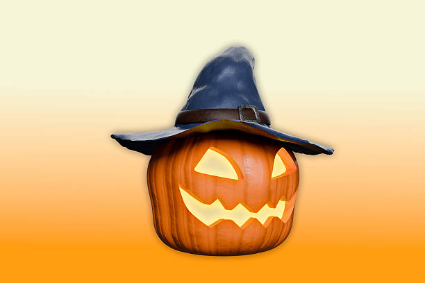 Perched on top of the pumpkin is a dark witch's hat with a pointed crown and a wide brim