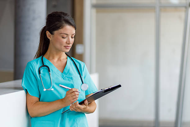 istock Female doctor writing notes on clipboard in hospital 2235511077