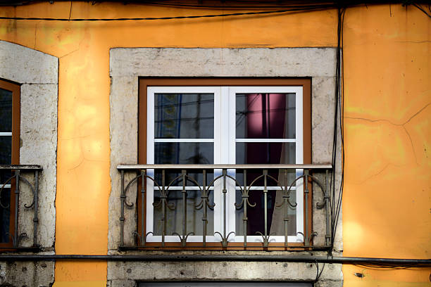Two broken windows of an old abandoned building with traditional portuguese tiles in porto