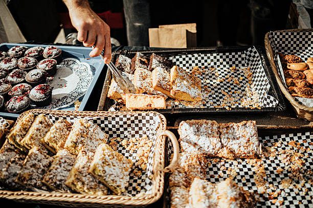 istock Assorted Pastries and Muffins at Outdoor Market Stall 2235512796