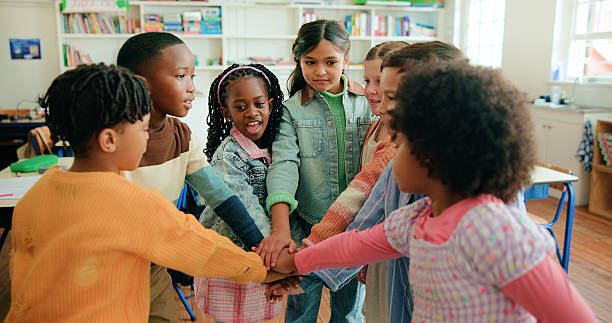 istock Stack of hands, celebration and kids in classroom for support, learning or education. Motivation, teamwork and group of students with growth, friendship or childhood development at elementary school. 2235513579