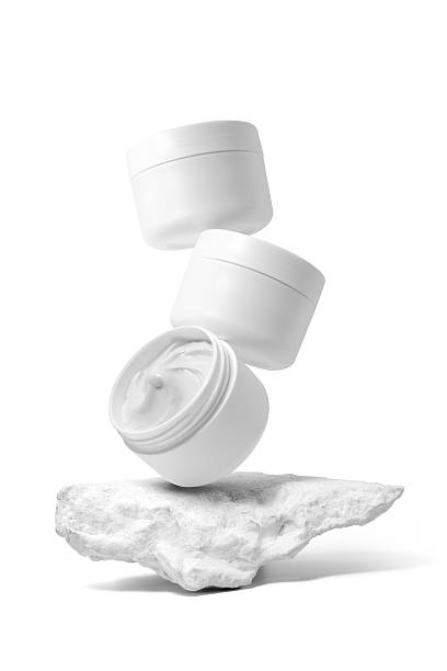 istock White plastic cosmetic jar with stone for mockup isolated on white background. Selective Focus. 2235513780