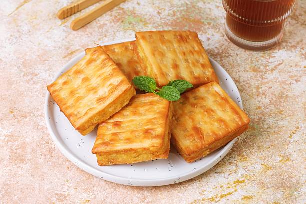 Stack of Crispy Gabin Tape Crackers with Tea Glass