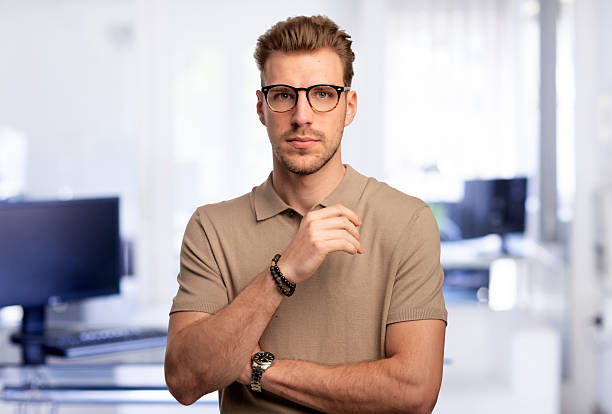 istock Confident young man standing at the office and looking at camera 2235522661