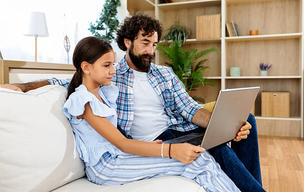 istock Father and daughter working together on laptop 2235522734