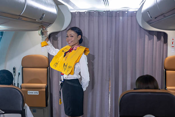 istock African flight attendant is demonstrating safety procedure using oxygen mask before taking off inside airplane for cabin crew and airline business concept 2235525548