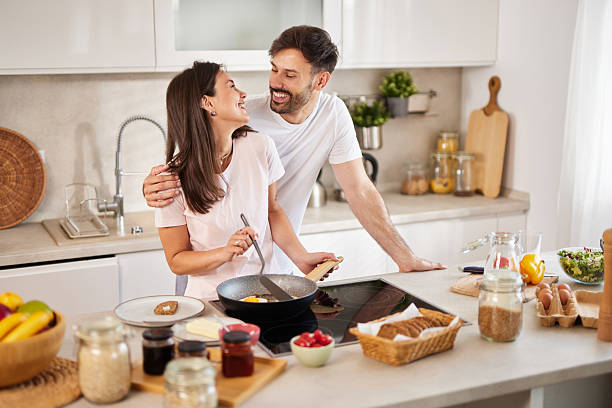 istock Young couple cooking breakfast together in modern kitchen 2235527969