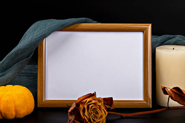istock Empty frame with copy space, decorative pumpkin, dried rose and candle for Halloween theme display 2235529117