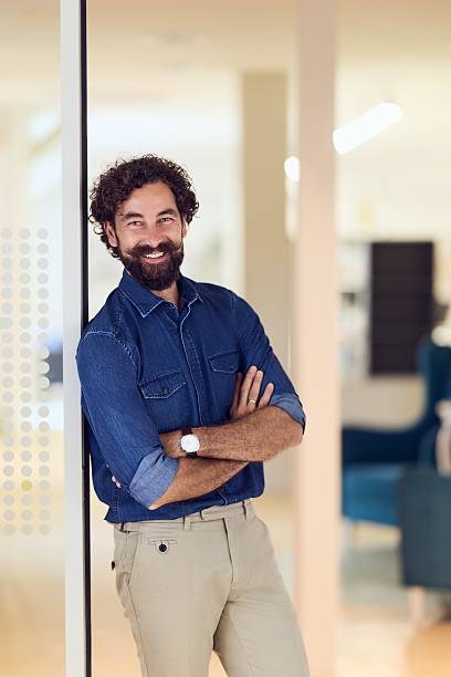 istock Confident Man in Modern Office Setting Wearing Casual Elegant Attire 2235529220