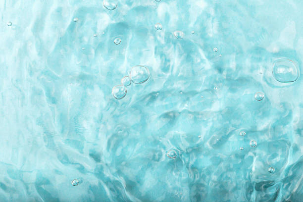 Blue water background with gentle ripples and bubbles, creating serene and tranquil ambiance, ideal for various design projects and visual storytelling