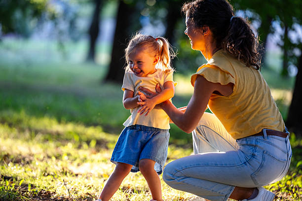 istock Joyful woman holding onto daughter after falling down 2235529775