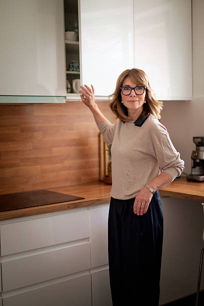 istock A woman standing in kitchen in her modern home 2235532511