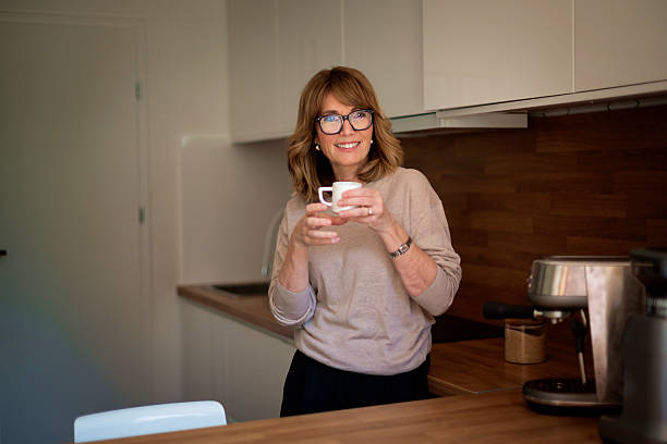 istock A woman standing in her kitchen and drinking her morning coffee 2235532534