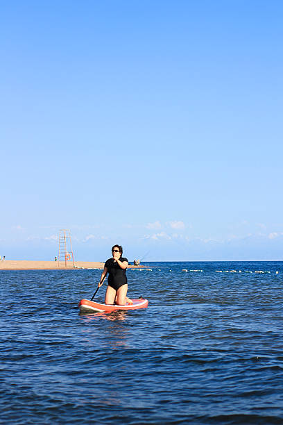 istock Woman paddleboarding in sea 2235535197