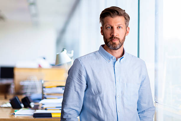 istock Confident business man standing at the office 2235535287