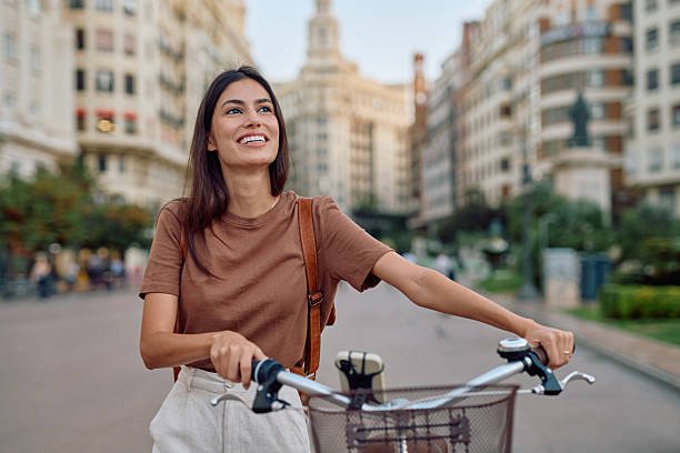 istock Young woman walking with her bicycle in Valencia, Spain 2235537361