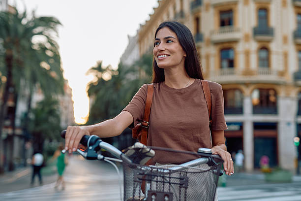 istock Young woman walking with her bicycle in Valencia, Spain 2235537420