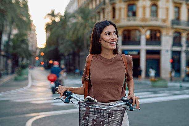 istock Young woman walking with her bicycle in Barcelona 2235537429