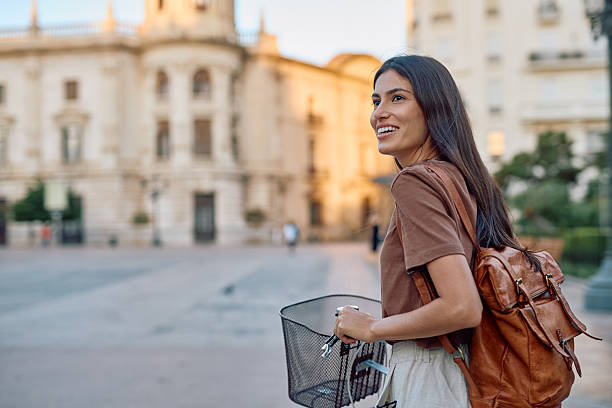 istock Young woman walking with her bicycle in Valencia, Spain 2235537463