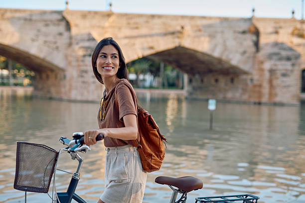 istock Young woman walking with her bicycle in Valencia, Spain 2235537502