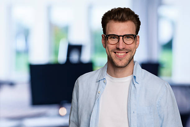 istock Young business man standing in a modern office space 2235537904