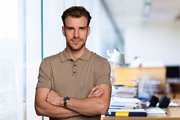 istock Young business man standing in a modern office space 2235537917