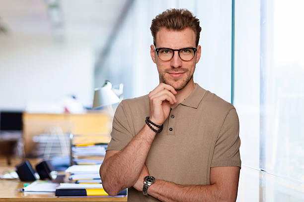 istock Young business man standing in a modern office space 2235537918