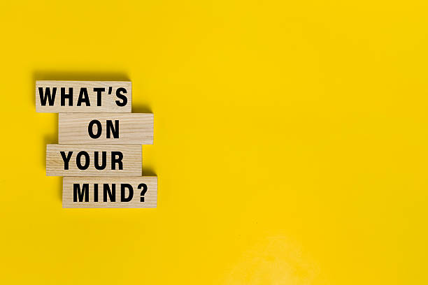 istock what's on your mind words on wooden blocks isolated on yellow background. copy space 2235540187