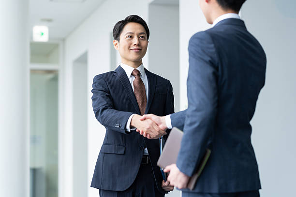 istock Businessmen shaking hands in the office 2235541918