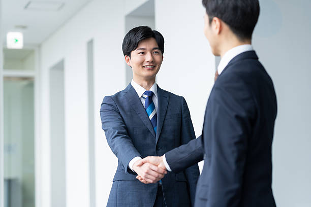 istock Businessmen shaking hands in the office 2235541923
