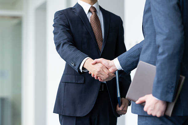 istock Businessmen shaking hands in the office 2235541928