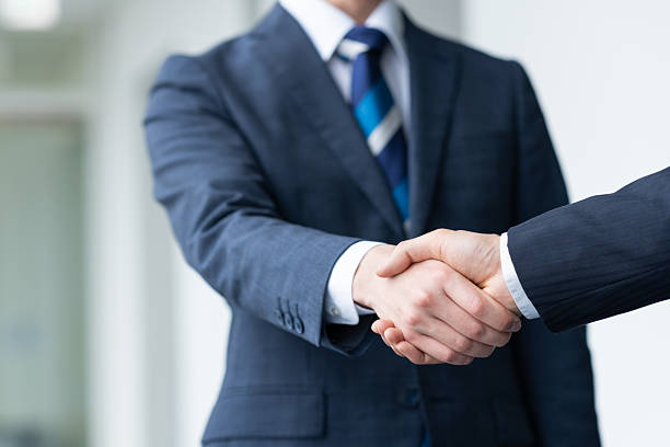istock Businessmen shaking hands in the office 2235541929