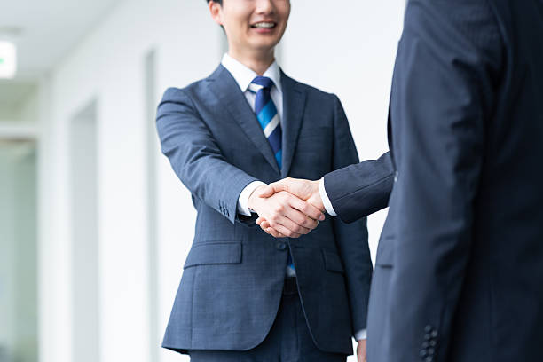istock Businessmen shaking hands in the office 2235541930