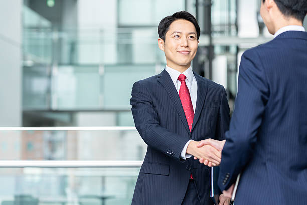 istock Businessmen shaking hands in the office 2235542024