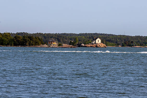 View over the archipelago near the city of Turku with a view on one of the islands with its typical Scandinavian wooden houses and a small harbour for leisure water activities