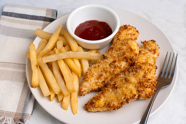 istock chicken tenders with  fries 2235544383