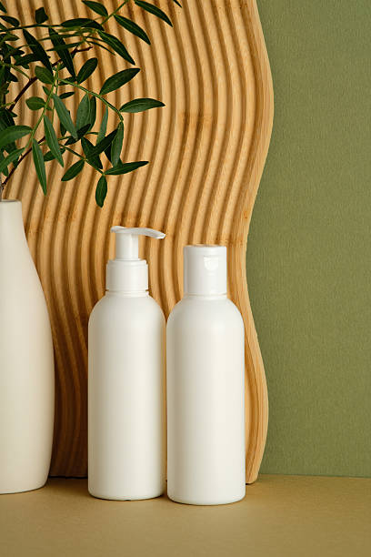 istock Minimalist skincare duo with white bottles and leafy decor 2235545192