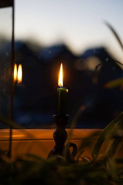 istock Candlelight in the dark room on a dark winter morning 2235545421
