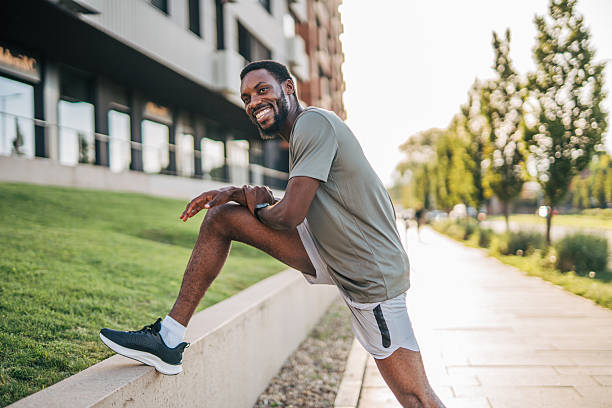 istock Young man stretching legs before running in the city 2235548712
