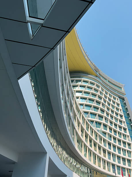 istock Abstract architecture background with modern curved building structure and reflective glass facade 2235549374