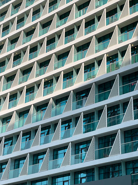 istock Modern residential building facade with balconies and glass windows, architectural pattern background, high resolution housing and real estate properties background 2235549388