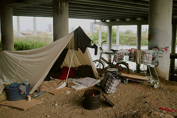 istock Homeless Camp under Bridge Showing Makeshift Tent and Personal Belongings 2235549600