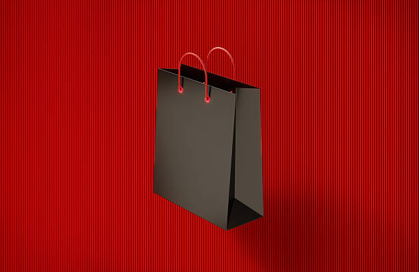 Black shopping bag on red background. Shopping concept.