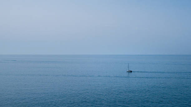 istock Single sailboat on calm Atlantic Ocean off Portugal 2235551528