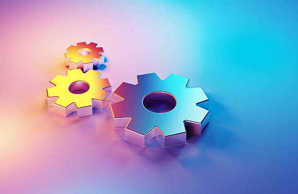 Metallic cogs illuminated by blue and magenta lights on magenta background . Horizontal composition with copy space.