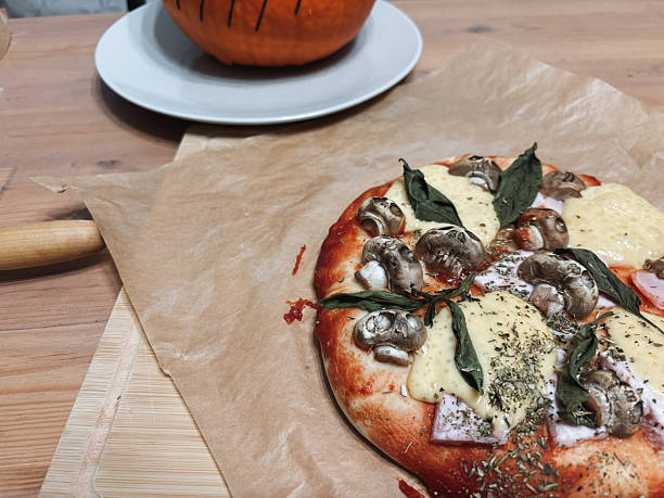 istock Homemade halloween pizza with mushroom skulls 2235556039